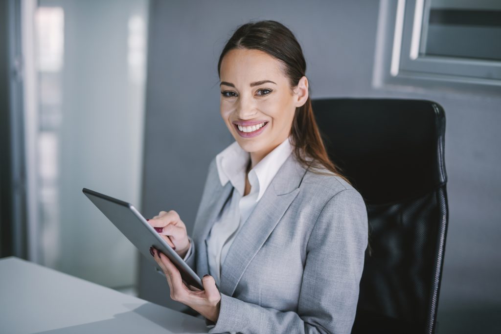Portrait of a businesswoman working on tablet at modern office.